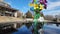 Footage of a colorful origami bouquet of flowers in the center of a pool reflecting off the water in at Atlanta Botanical Garden