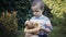 Footage farm boy holding a small chick in the hands outdoor.