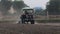 Footage of A farmer sits on a tractor, sowing seeds in the field, india