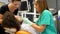 Footage of a female dentist and her assistant checking a young manÂ´s teeth