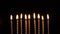 Footage golden burning candles set on black background. 4K