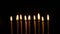 Footage golden burning candles set on black background. 4K