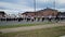 footage of the Grambling State Marching Band marching through the Grambling State University campus with red brick buildings