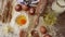 Footage of ingredients prepared to make pastry. Eggs, milk, flour on table top view shot. Slow motion video.