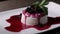 Footage of a panna cotta cake on a white plate, the shot is moving from the left to the right