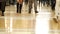 Footage of people\'s legs in a shopping mall going in different directions