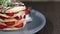 Footage of a portion of pancakes decorated with strawberries on a plate lying on a table, the shot is coming into focus and goes a