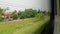 Footage rice field, mountain, forest, railroad track, view from window inside train