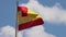 Footage of a Spanish flag blowing in the wind on a bright sunny summers day with blue sky, taken in the town of Ibiza