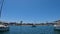 footage of a stunning summer landscape in the canal with boats and yachts docked along the banks on the rippling blue ocean water