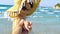 Footage of a Turkish Woman with straw hat and yellow dress enjoying on the beach