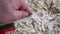 Footage of a wooden spoon carving with sandpaper on a workbench with wood chips, Germany