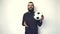 Footage of young bearded man playing with soccer ball over white background