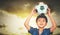 Football Asian boy is holding soccer ball on his head for Youth sport concept