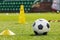 Football Background. Sports Soccer Training Equipment. Classic Football Ball, Training Cones, Markers and Ladder on Grass Turf