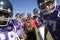 Football Coach and Players holding trophy on field