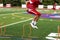 Football cross training by jumping hurdles