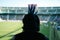 Football fan with crest hairstyle, watching a match from the stand