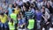 Football fans pass through security before soccer match. Guard checking people