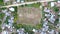 Football field among houses in zanzibar, aerial, topview