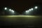 Football field illuminated by floodlights at night. Generative AI.