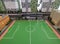 Football field in miniature among high-rise houses
