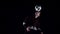 Football freestyle. Football player making tricks with ball at dark studio. Slow motion