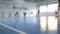 Football futsal training for children. Indoor soccer young player with a soccer ball in a sports hall.