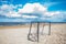 The football gate left on the empty beach in a bright sunny day of the beginning of autumn