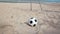 Football and goal on sand beach and blue sky background in HD, dolly tracking camera shot at day light time