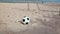 Football and goal on sand beach and blue sky background in HD, dolly tracking camera shot at day light time