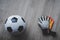 Football Goalkeeper gloves and soccer ball top view on wooden backgorund with copy space