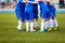 Football match for children. Youth sports team celebrate.