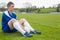 Football player in blue taking a break on the pitch