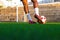 Football player feet running with the ball in front of the field. Player feet with the ball scoring a goal.
