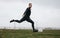 Football player practicing his kicks on the field on a cloudy day. Man playing soccer on field about to kick the ball