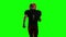 Football player running with the ball and throws it to the side. Green screen, back view
