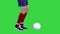 Football player's feet dribbling a ball and making a pass on a Green Screen, Chroma Key.