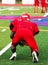 Football player in three point stance at practice