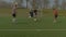 Football players training on soccer field in spring