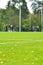 On a football practise and on a green field on a rainy, cold and grey Autumn afternoon with soccer players on a background