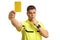 Football referee blowing a whistle and showing a yellow card