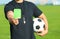 Football referee showing green card at stadium