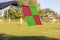 Football soccer arbiter assistant with flag at hands. Blurred green field background