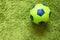 Football Soccer ball on a green surface imitating artificial grass. Sports photography