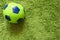 Football Soccer ball on a green surface imitating artificial grass. Sports photography