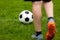 Football or soccer ball at the kickoff of a game. Soccer free kick at a grass pitch