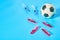 Football, soccer ball near syringe and ampoule on blue background. Concept of doping in professional sport