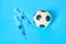 Football, soccer ball near syringe on blue background. Concept of doping in professional sport