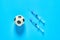 Football, soccer ball near syringe on blue background. Concept of doping in professional sport